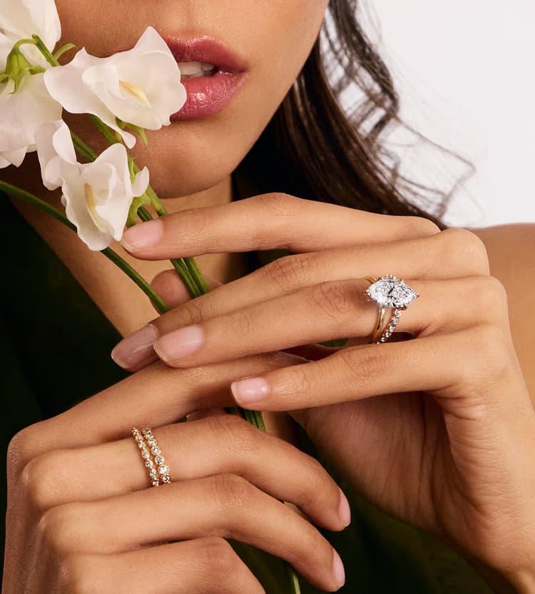 A close-up of an engagement ring with text overlay reading 'Find the Perfect Ring, Make it yours' against a dark background